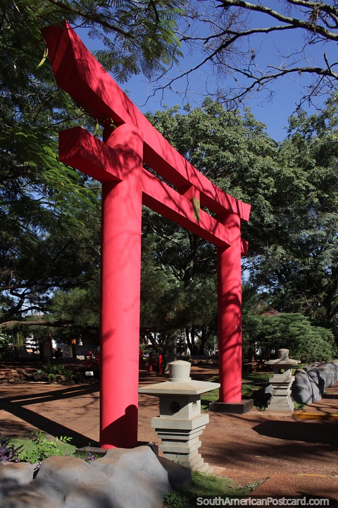 Red gate to the Japanese gardens at the Plaza de Armas in Encarnacion. (480x720px). Paraguay, South America.