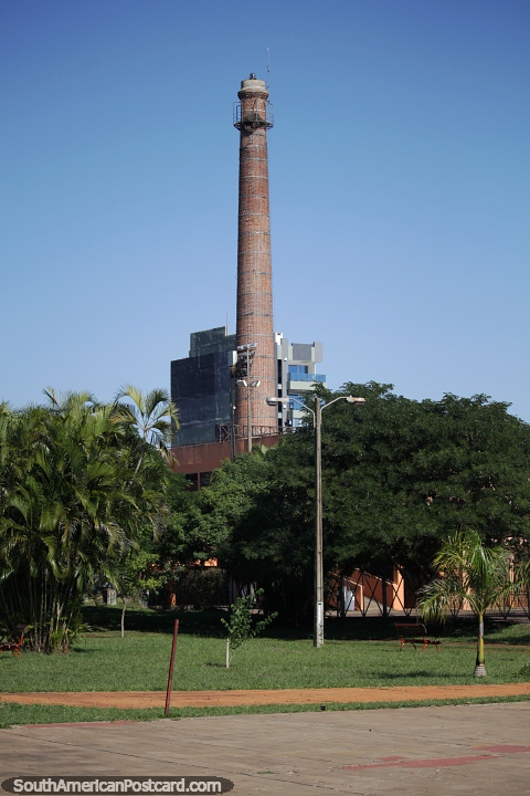 Tall brick tower in the skyline, view from the park in Encarnacion. (480x720px). Paraguay, South America.