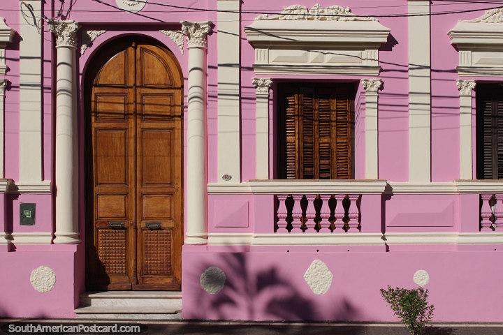 Clubhouse with pink facade, fancy trimmings, wooden door and window shutters in Villarrica. (720x480px). Paraguay, South America.