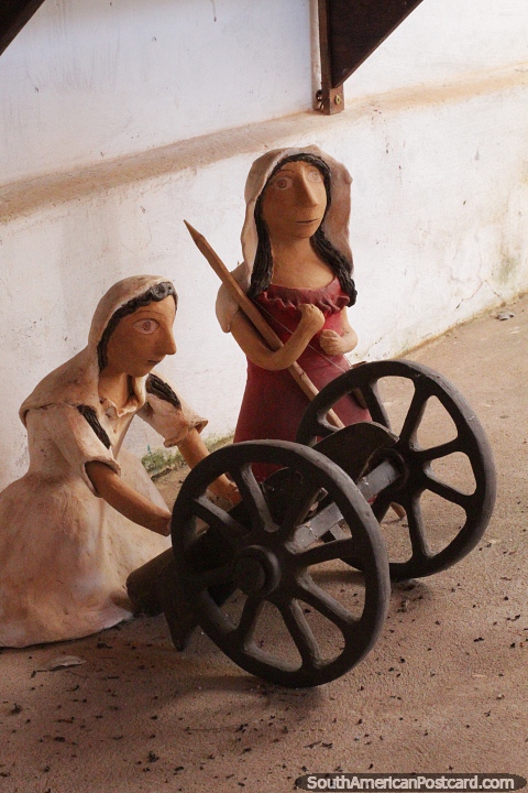 Pair of women with a cart, ceramic work outside the museum in San Ignacio Guazu. (480x720px). Paraguay, South America.
