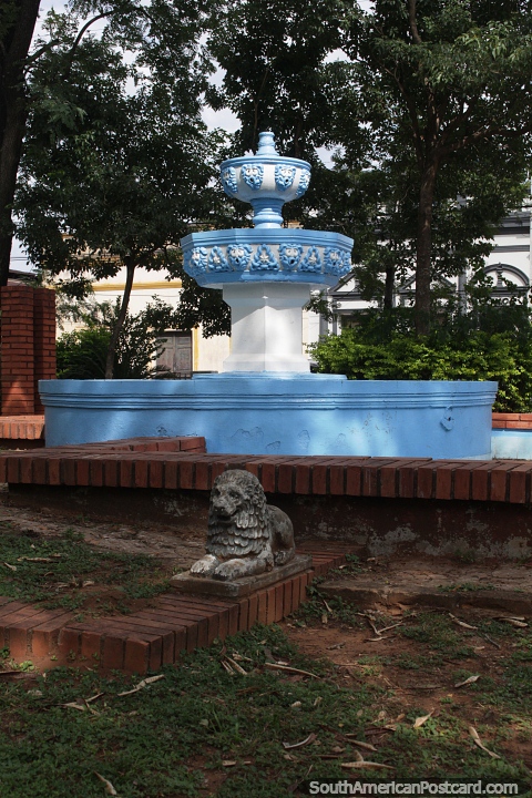 Fountain and stone lion at Plaza Mariscal Lopez in Paraguari. (480x720px). Paraguay, South America.