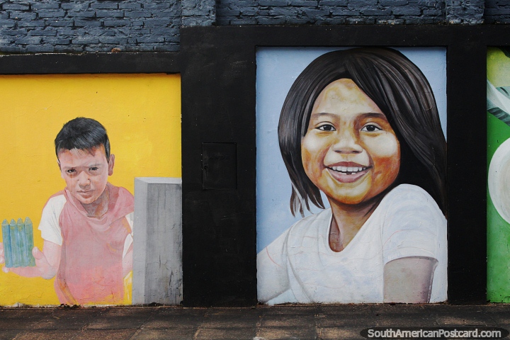 Street murals of a smiling girl and boy in Caacupe. (720x480px). Paraguay, South America.