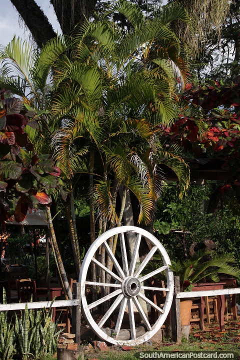 White wooden wagon wheel as part of the fencing around a property in Aregua. (480x720px). Paraguay, South America.