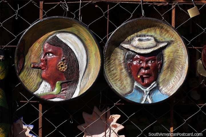 Plates with faces for hanging on the wall made from ceramic in Aregua. (720x480px). Paraguay, South America.