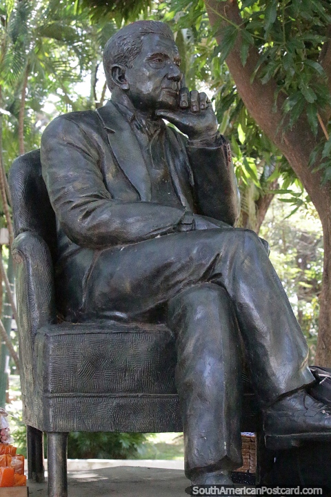 Statue of a man sitting in a chair at Plaza Uruguaya in Asuncion. (480x720px). Paraguay, South America.
