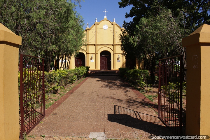 San Estanislao Church, view from the gates to the yellow church and gardens. (720x480px). Paraguay, South America.