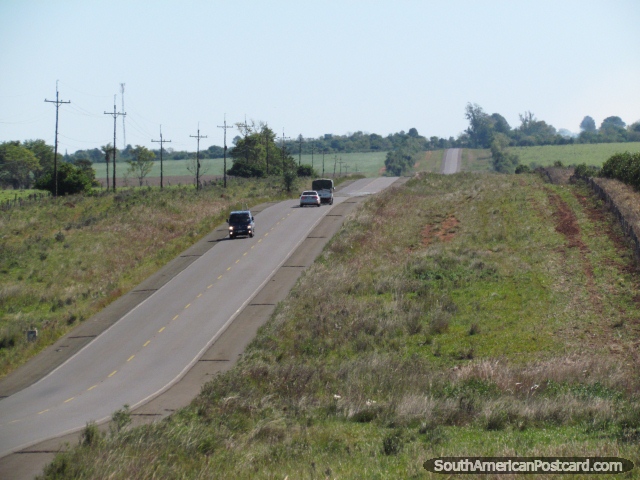 Cars rolling along Route 1 in the countryside between General Delgado and Santa Rosa. (640x480px). Paraguay, South America.