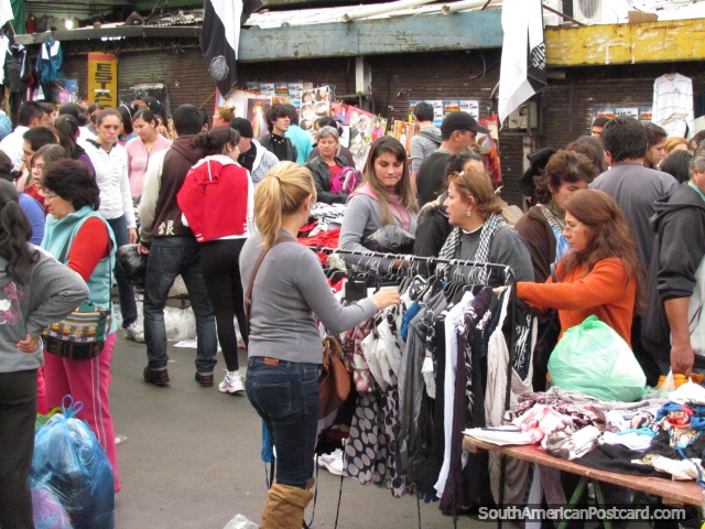 Clothes racks and people, Guasu Markets, Asuncion. (640x480px). Paraguay, South America.