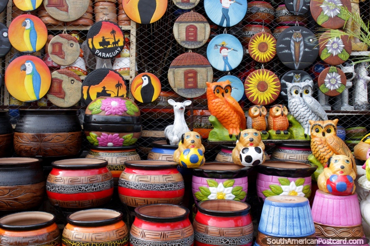 Colorful plant holders and wall plaques, a few owls, ceramic art from Aregua. (720x480px). Paraguay, South America.
