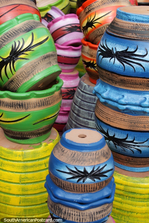 Pot plant holders in a rainbow of colors, made from ceramics in Aregua. (480x720px). Paraguay, South America.