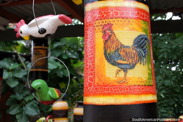 A ceramic with a painted rooster, a pair of parakeets beside, Aregua. (720x480px). Paraguay, South America.