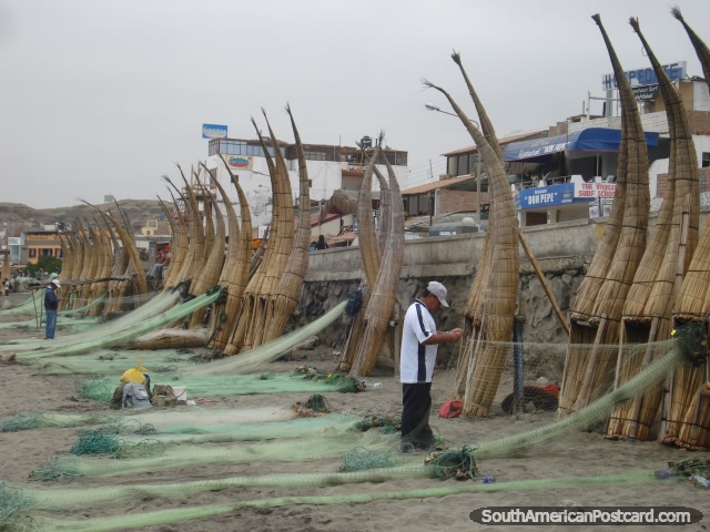 Fishermen getting the nets ready on the banana boats of Huanchaco. (640x480px). Peru, South America.