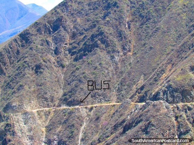 Bus on the cliff road is dwarfed by the huge mountain faces between Leymebamba and Celendin. (640x480px). Peru, South America.