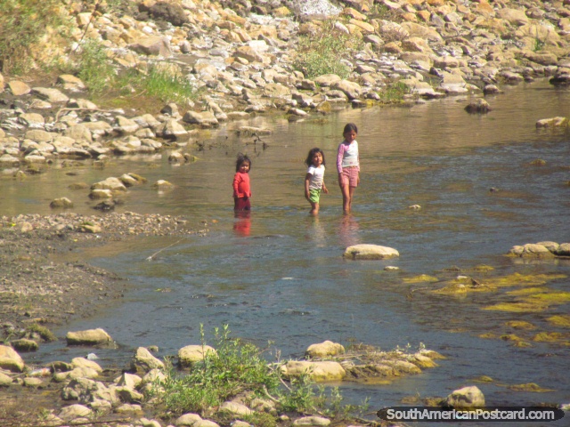 3 girl children cross a river north of Cajabamba. (640x480px). Peru, South America.
