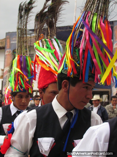 Young men wear hats of colored strips and feathers at Feria Patronal, Huamachuco. (480x640px). Peru, South America.