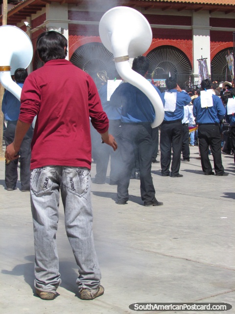 Man lets off skyrocket and brass band plays at Feria Patronal in Huamachuco. (480x640px). Peru, South America.