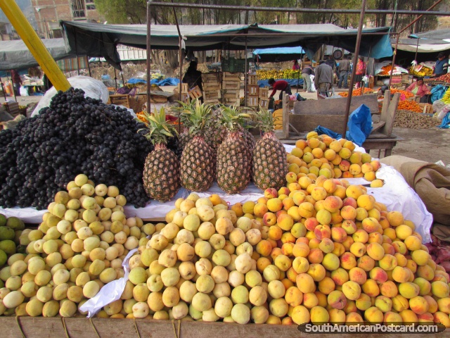 Peaches, pineapples and grapes, fruit stall at Andahuaylas market. (640x480px). Peru, South America.