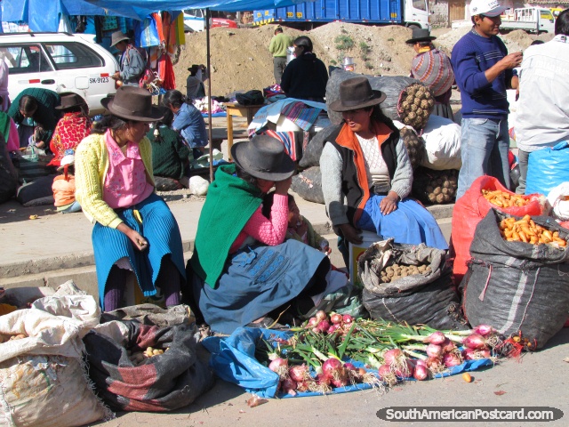Quechua indigenous with sacks of produce they bring to market in Andahuaylas. (640x480px). Peru, South America.