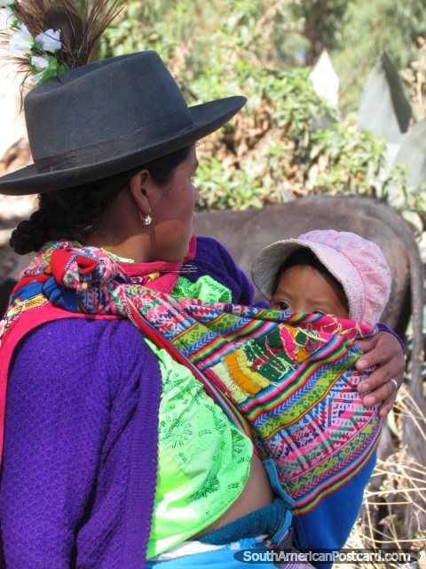 Indigenous Quechua woman and baby at Andahuaylas markets. (480x640px). Peru, South America.