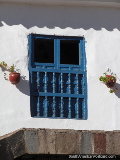 Wooden window and flower pots in Cusco. (480x640px). Peru, South America.