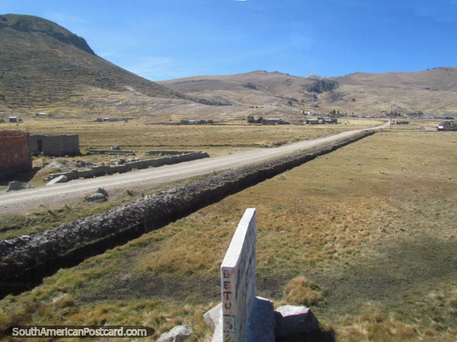 Terrain and long straight road north/west of Desaguadero. (640x480px). Peru, South America.