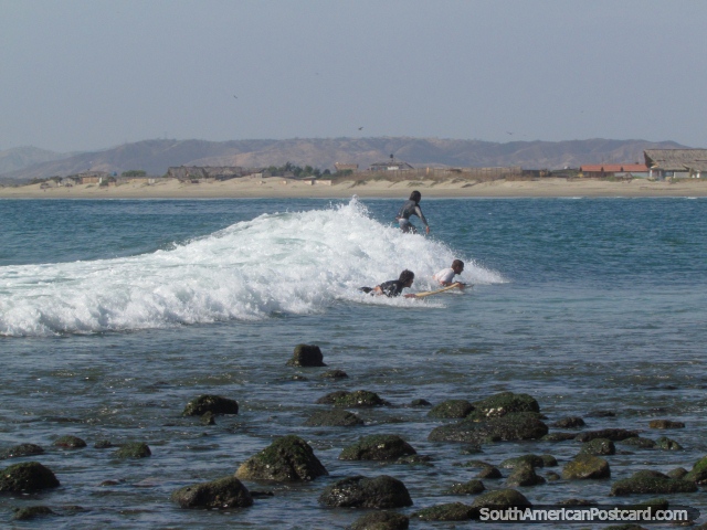 A group of surfers on a wave at Mancora. (640x480px). Peru, South America.