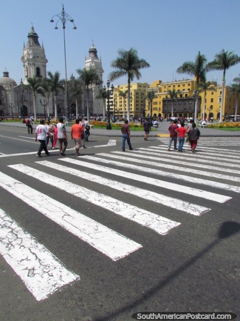 People cross the road towards the Plaza de Armas in Lima. (480x640px). Peru, South America.