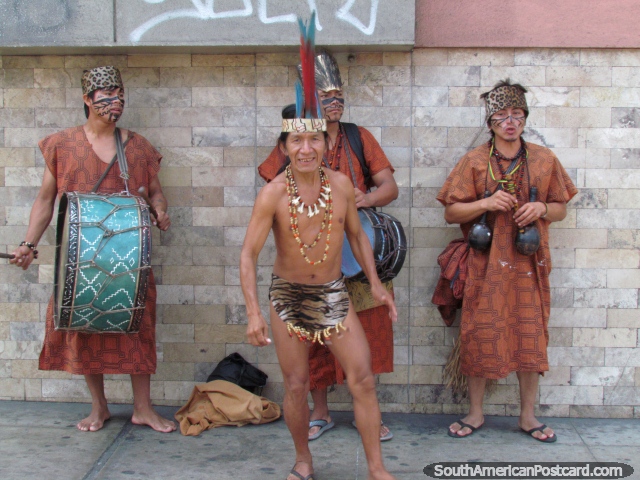 An indigenous musical group in costumes perform on the street in Lima. (640x480px). Peru, South America.