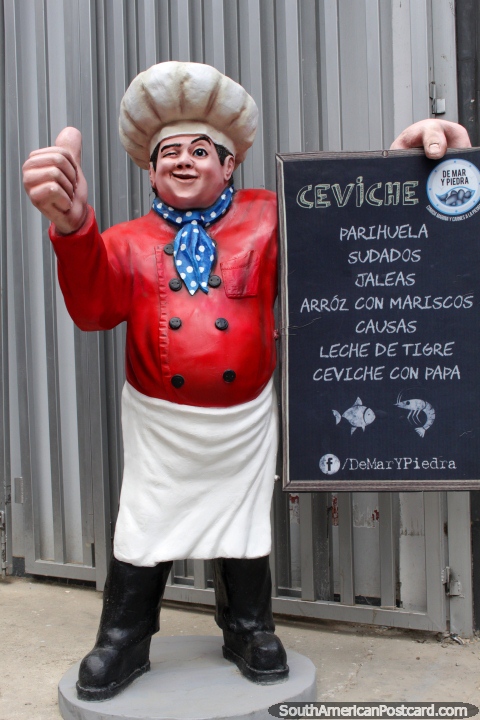 Chef character holding menu outside De Mar y Piedra Restaurant in Huanuco. (480x720px). Peru, South America.