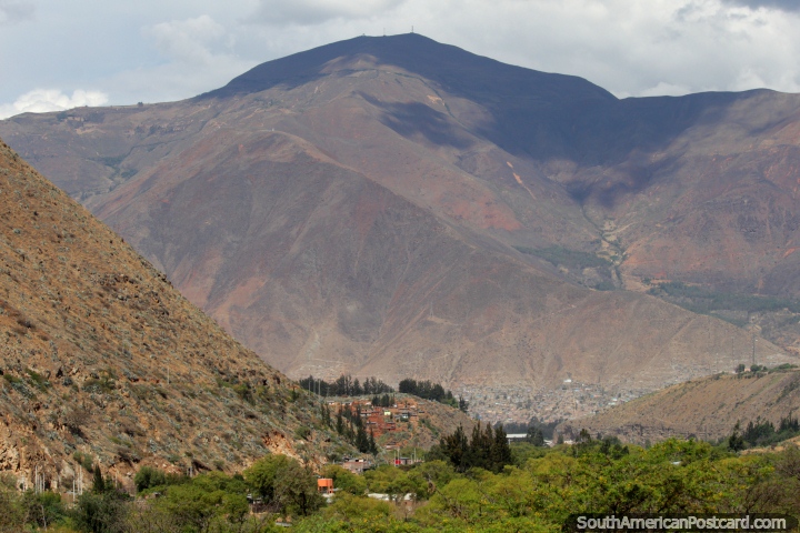 View of Huanuco in the far distance below a great mountain, view from Kotosh. (720x480px). Peru, South America.