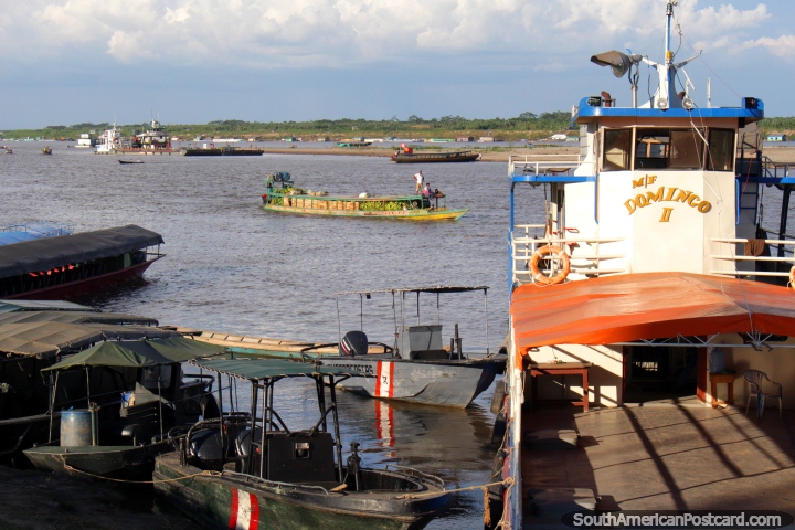 Bananas and wooden crates come down river by boat in Pucallpa. (720x480px). Peru, South America.