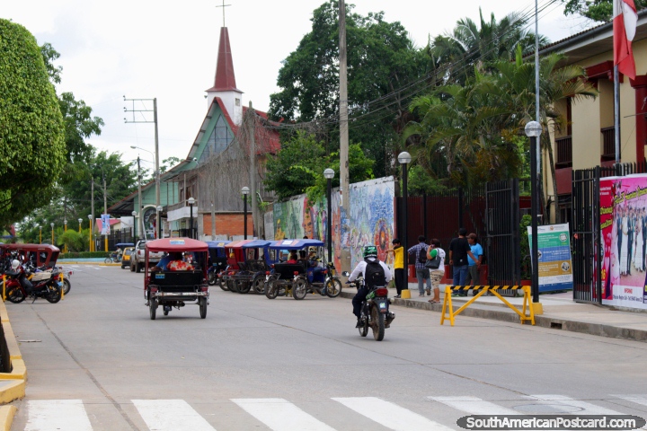 Street beside the plaza with church and murals in Yarinacocha, Pucallpa. (720x480px). Peru, South America.