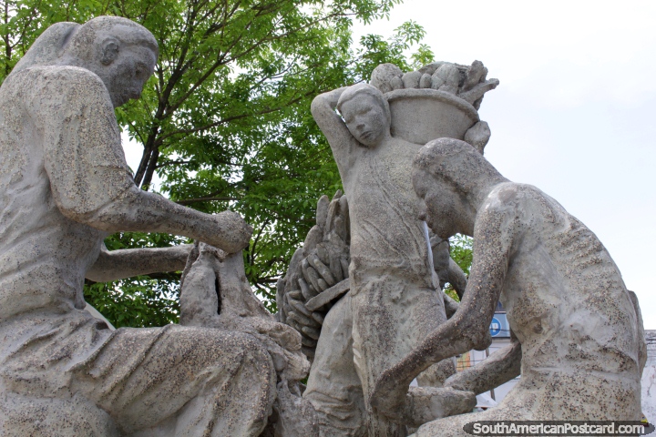 An indigenous family at work, stone monument at the Plaza de Armas in Pucallpa. (720x480px). Peru, South America.