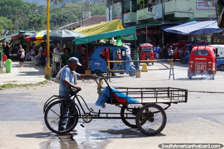 Man and trolley cart, street stalls and mototaxis, Tingo Maria. (720x480px). Peru, South America.