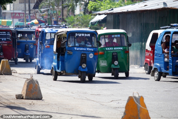 The green mototaxi is a rare breed in Tingo Maria, red and blue dominate. (720x480px). Peru, South America.