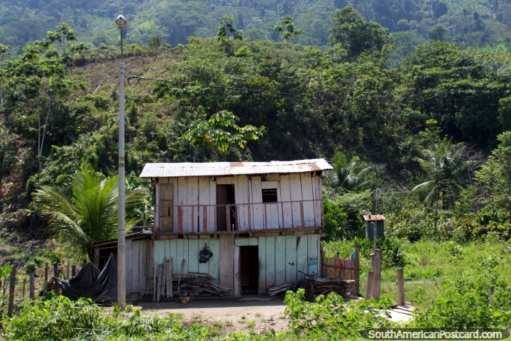 Wooden house with 2 levels, hills behind, Tingo to Tocache. (720x480px). Peru, South America.