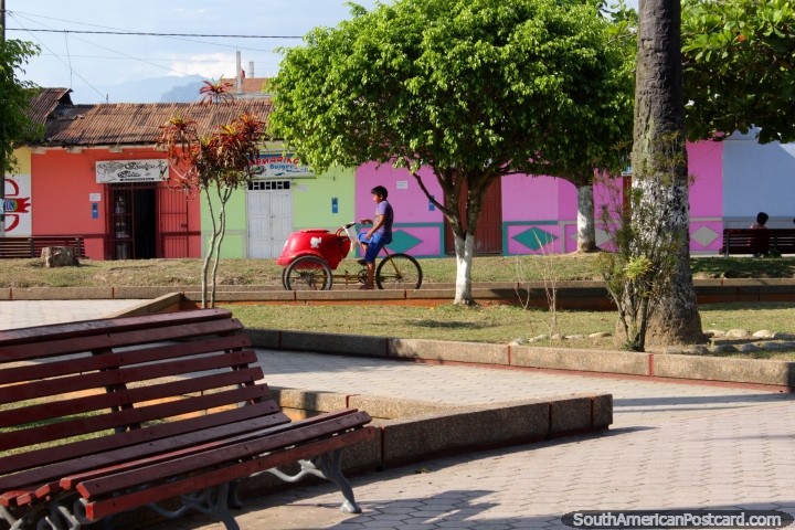 Boy selling ice-cream rides around the plaza in Tocache. (720x480px). Peru, South America.
