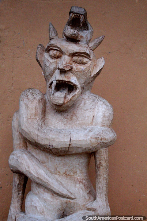 An Amazon Devil with his tongue out, indigenous crafts made of wood at Wayku Plaza in Lamas. (480x720px). Peru, South America.