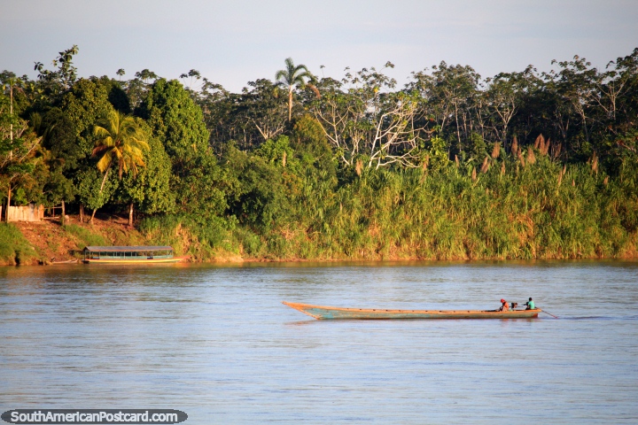 Motorized river canoe powers up the Huallaga River near Yurimaguas. (720x480px). Peru, South America.