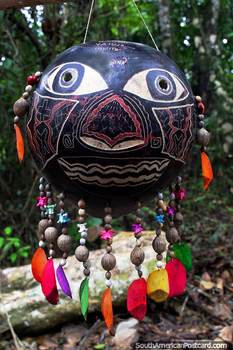 Indigenous art from the jungle, carved face and colored pieces, Iquitos. (480x720px). Peru, South America.