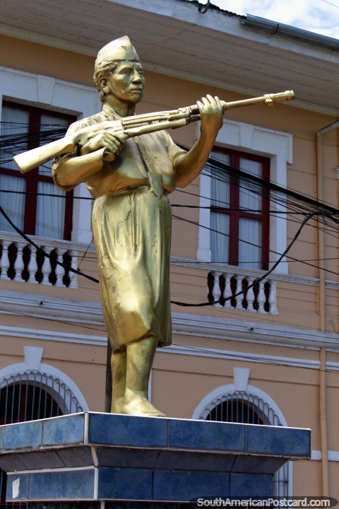 Balbina Dora Soto Correa (1926-2001), gold statue in Iquitos, a hero holding gun. (480x720px). Peru, South America.