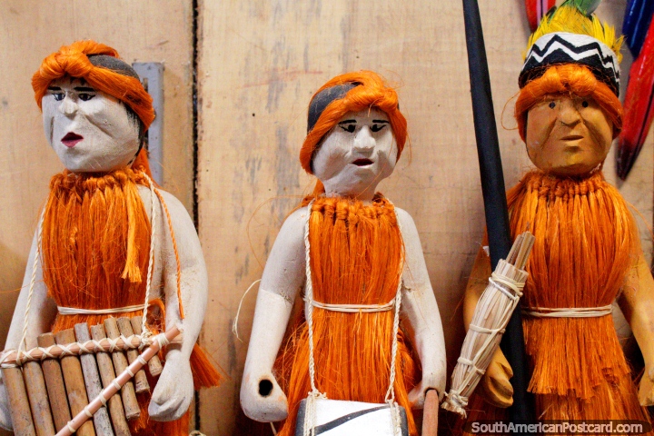 3 figures in orange carrying different items, Anaconda Arts Center, Iquitos. (720x480px). Peru, South America.