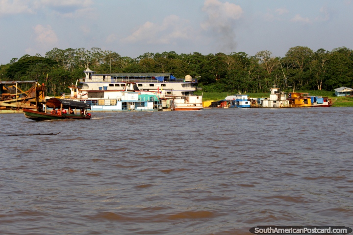 View of Leticia Colombia across the Amazon River as we leave Santa Rosa Peru by riverboat. (720x480px). Peru, South America.