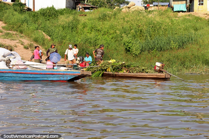 People and their produce on the banks of the Amazon River as we arrive in Leticia Colombia from Santa Rosa. (720x480px). Peru, South America.
