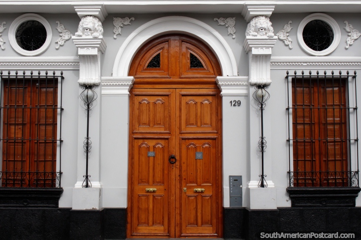 Beautiful building facade in Arequipa with arched wooden door and window shutters. (720x480px). Peru, South America.