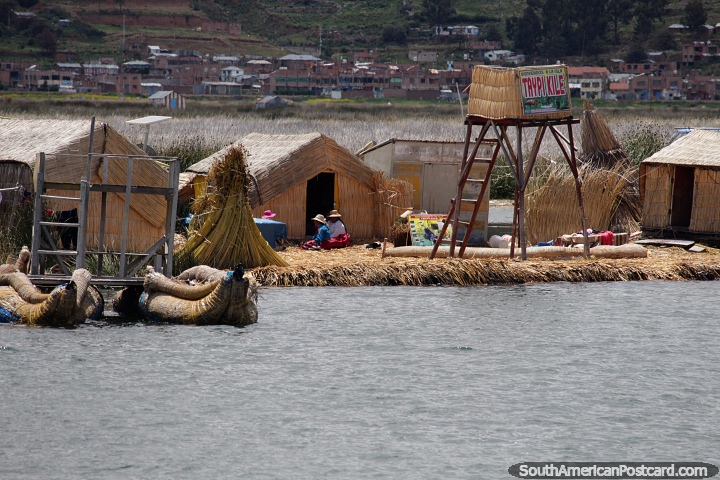 Taypi Kyle floating reed island with thatched houses, watchtower and solar power, Puno. (720x480px). Peru, South America.