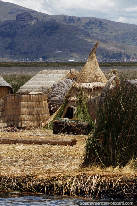 The Uros people live offshore from Puno on floating reed islands in thatched housing. (480x720px). Peru, South America.
