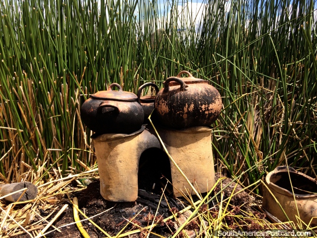 The Uros people of Puno cook over a fire with ceramic pots. (640x480px). Peru, South America.