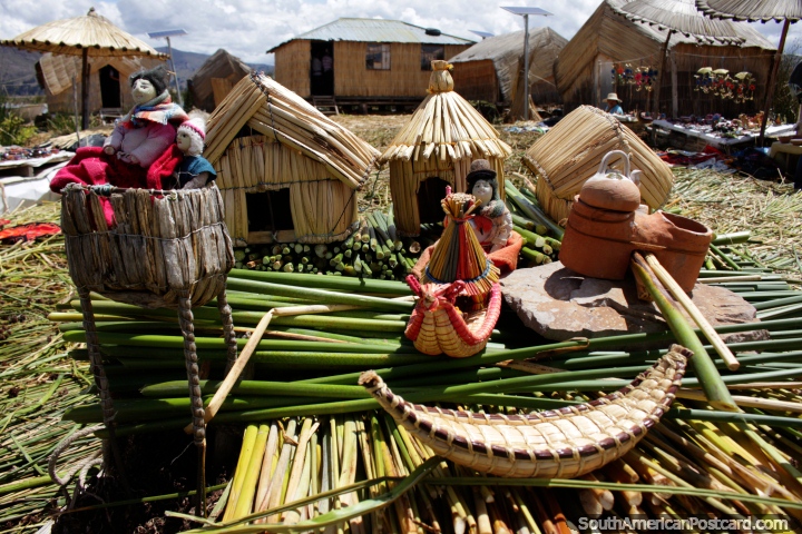 Model of a floating reed island sits upon a real floating reed island in Puno. (720x480px). Peru, South America.