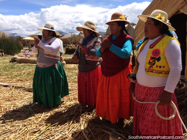 4 Uros wives sing a song as we depart their island at Lake Titicaca in Puno. (640x480px). Peru, South America.